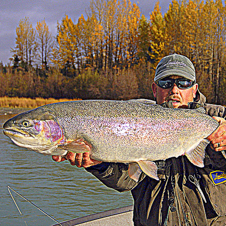 man holding trophy-sized rainbow trout
