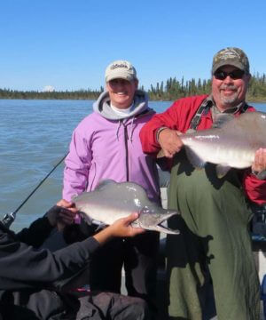 group of fishermen holding pink salmon